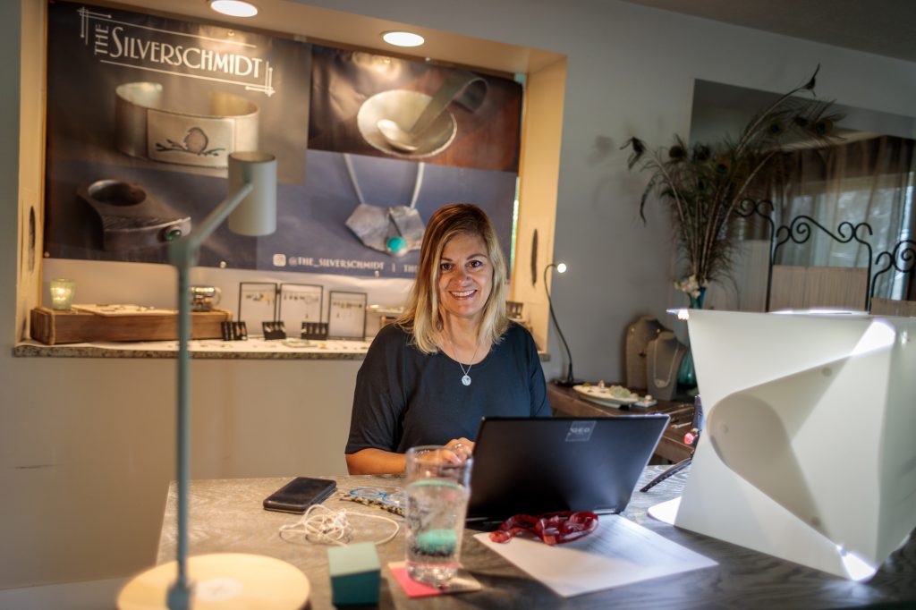 Jewelry Artisan Sitting At Desk 